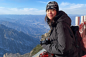 Luoshu standing looking at the view at a mountain range. Photo.